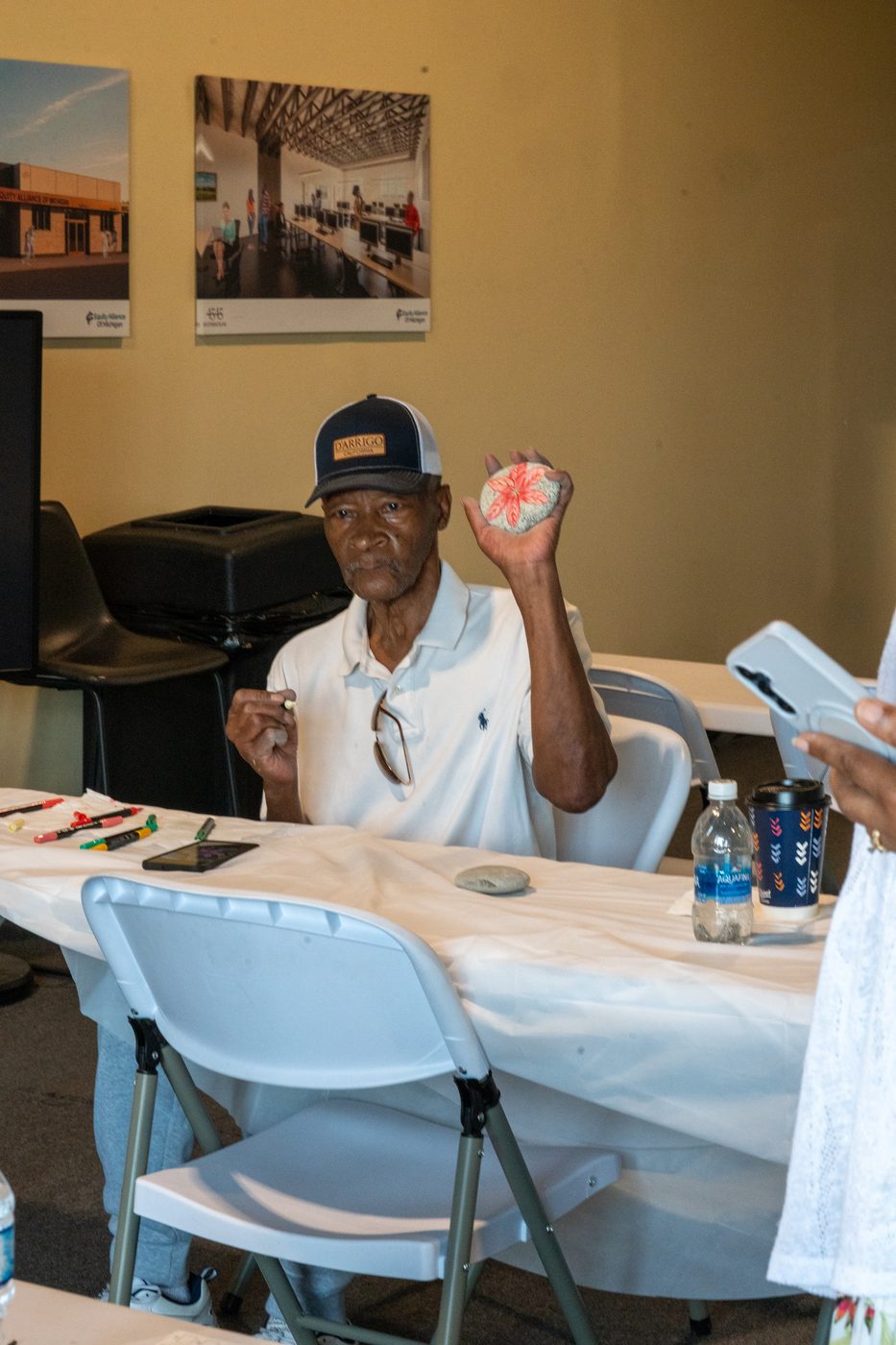 Senior holding painted rock